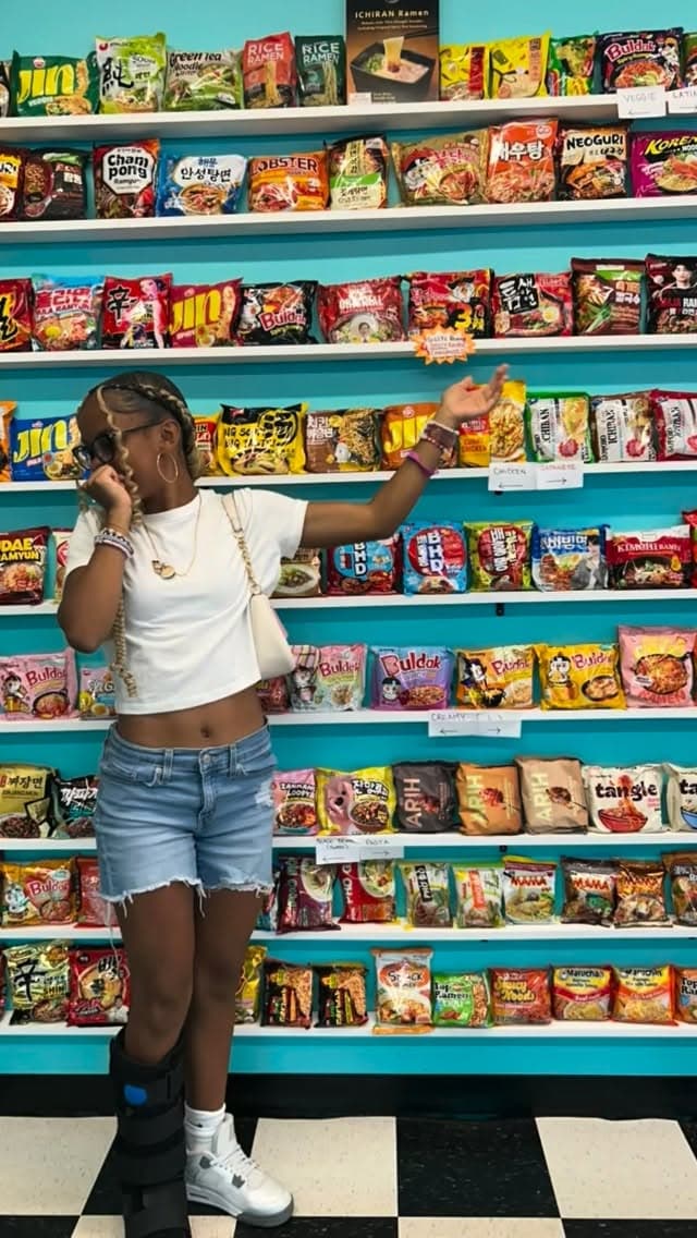 The Instaclaw ramen wall — shelves stacked with over 160 instant ramen varieties